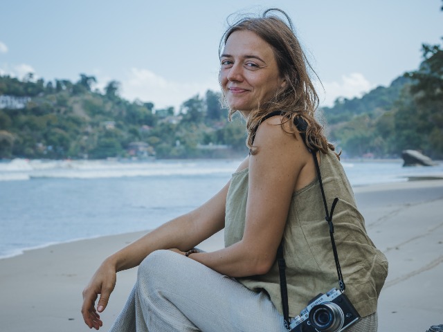 Denise at Las Cuevas, her favorite beach on Trinidad's north coast, taking photographs of the Trinidadian landscape as part of her project.