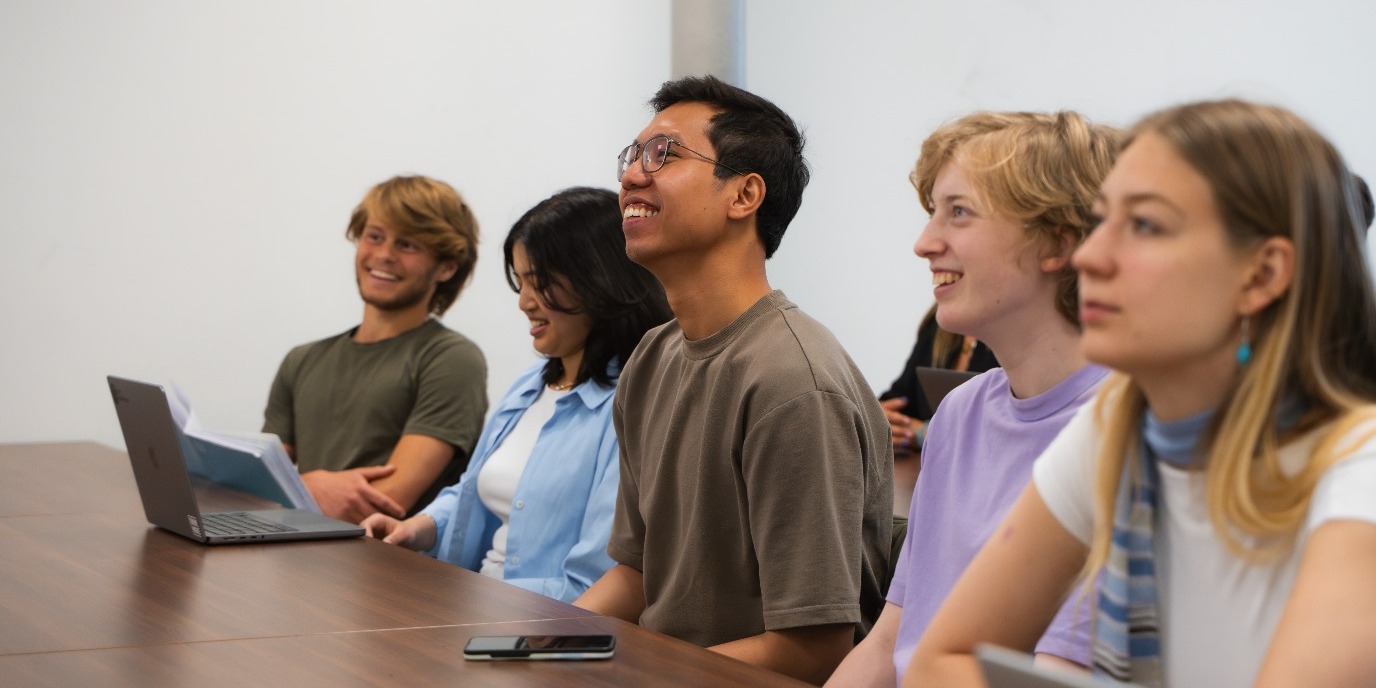 Students smiling in a class room