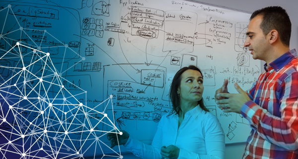 Image of two people in front of a whiteboard